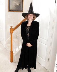 Старуха в черном пальто и шляпе раздевается в прихожей 1 фотография