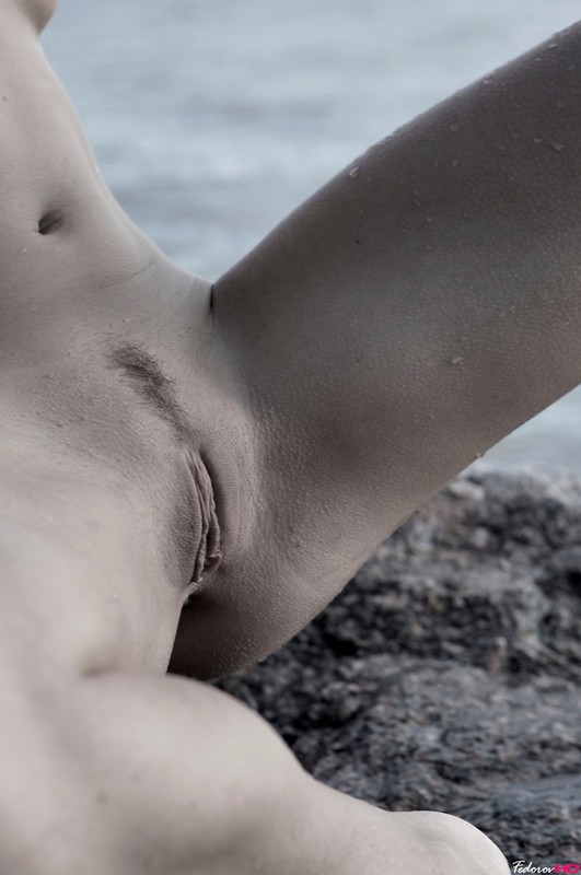 Молодуха на скалистом берегу моря светит обнаженным телом 6 фото